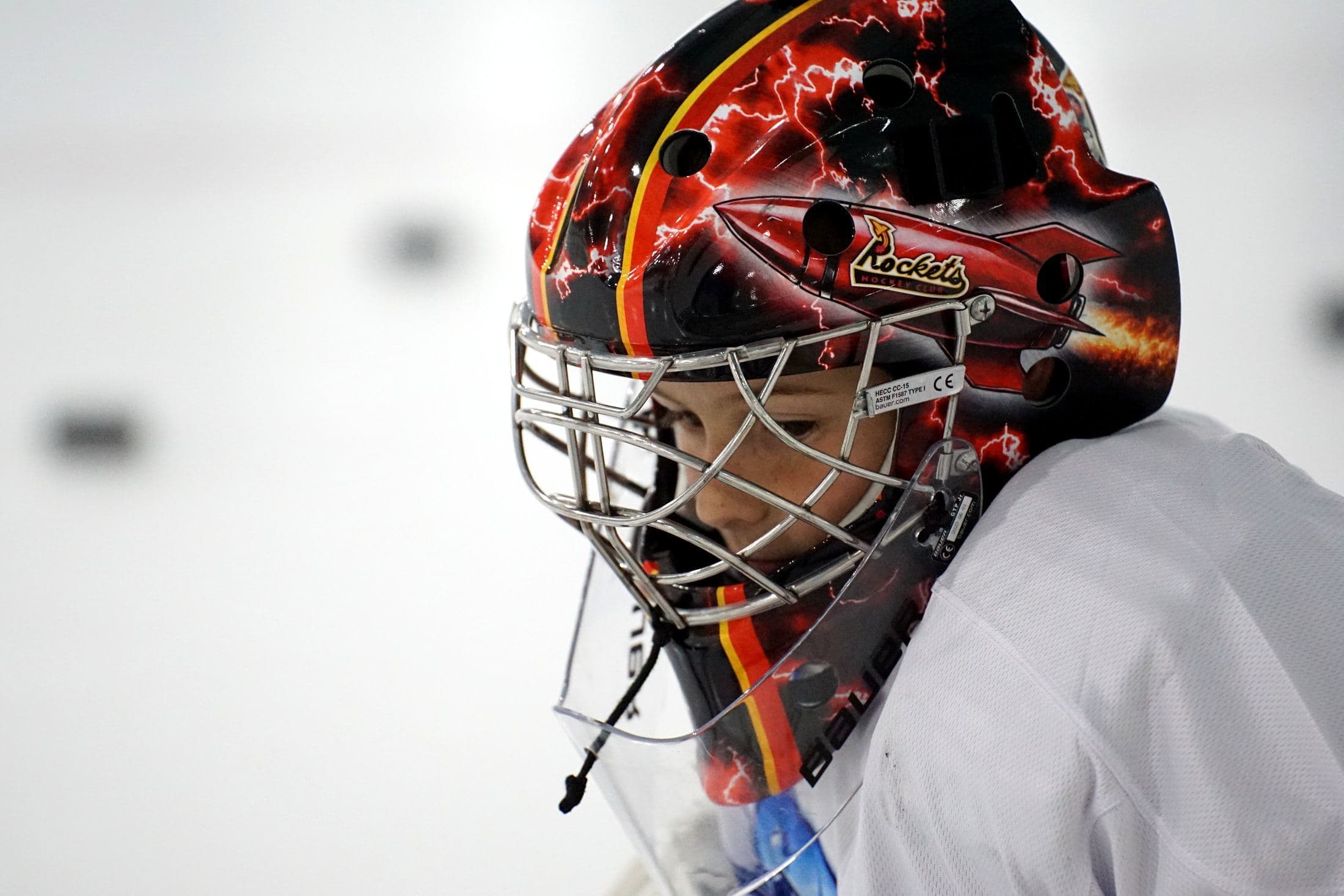 A goalie in a painted mask, close up
